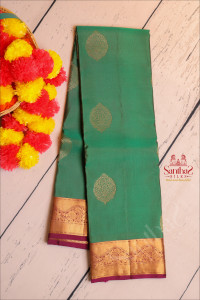 green-colour-body-with-goldern-zari-butta-with-contrast-blouse-border