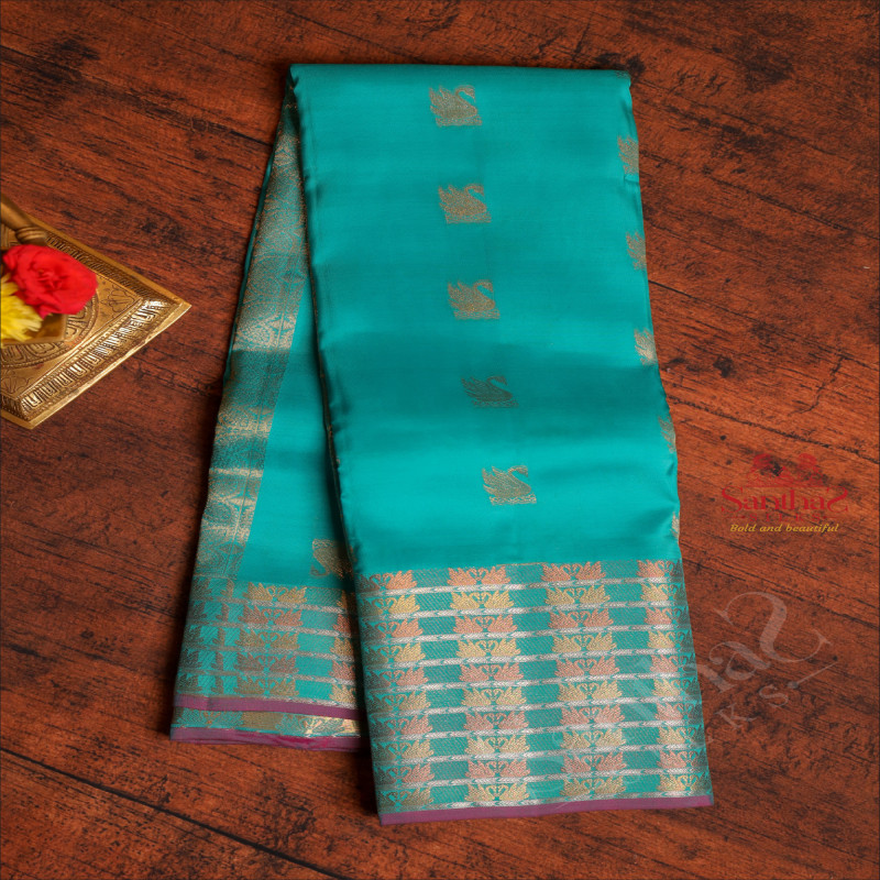 PARSIAN GREEN COLOUR BODY WITH GOLDEN ZARI CRANE MOTIFS AND SELF COLOUR PALLU & BLOUSE