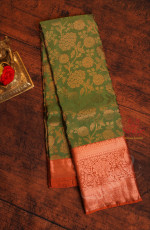 JADE GREEN COLOUR BODY WITH JACQUARD FLORAL EMBOSED IN COPPER ZARI WITH CONTRAST RED BLOUSE & BORDER