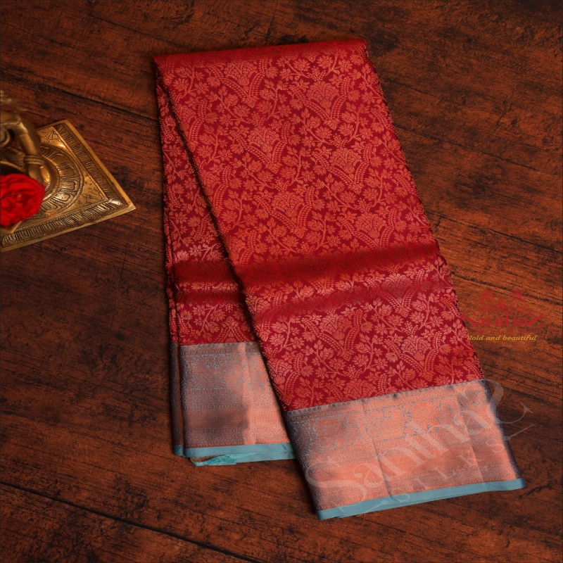 MAROON COLOUR BODY WITH JACQUARD FLORAL EMBOSED IN COPPER ZARI WITH CONTRAST BLUE BLOUSE & BORDER